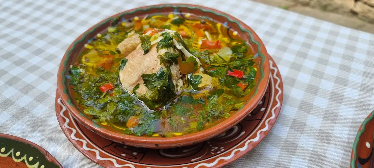 Traditional Zeamă chicken broth with herbs